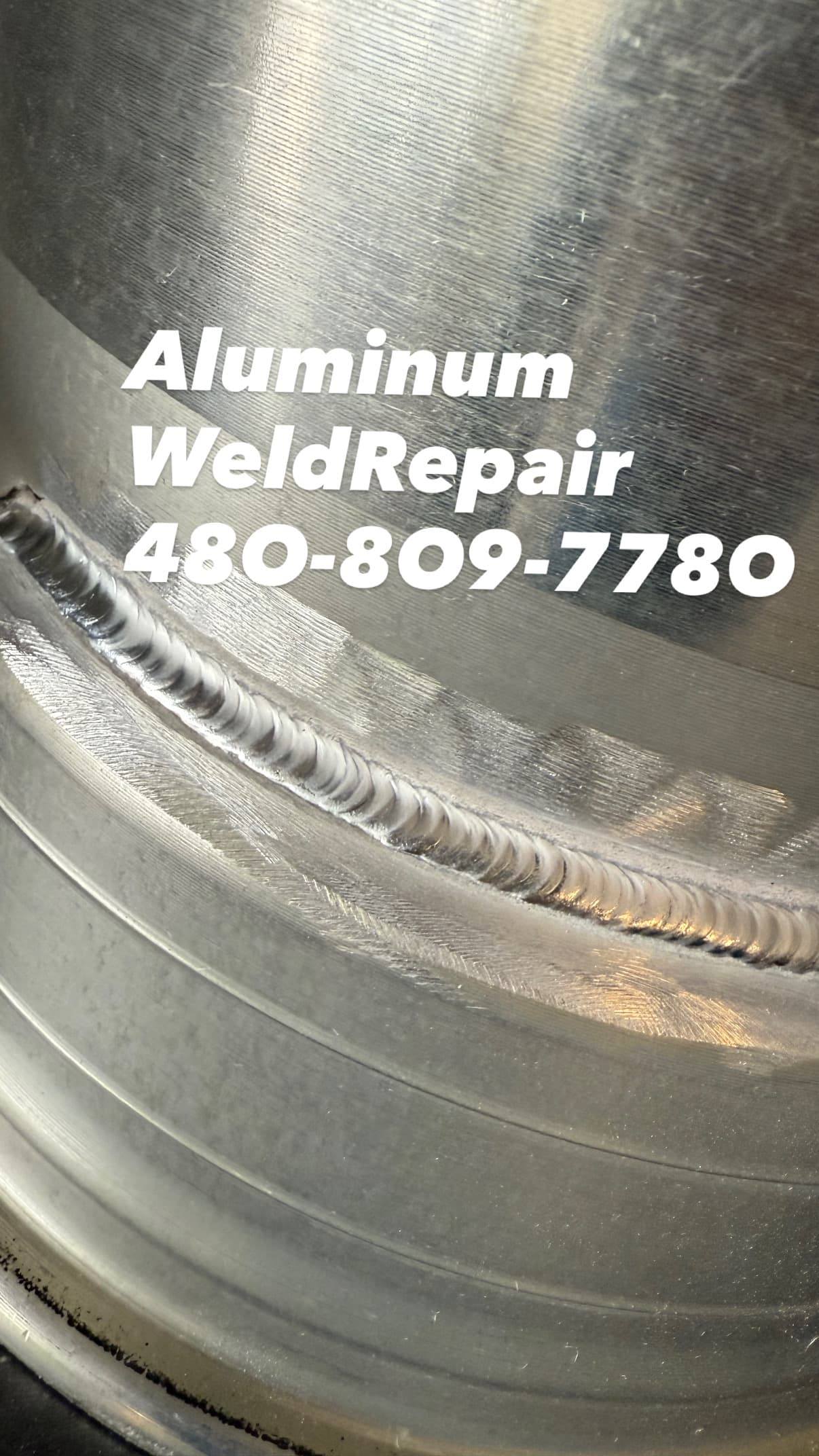 Close-up of a professional aluminum weld repair with contact phone number 480-809-7780.